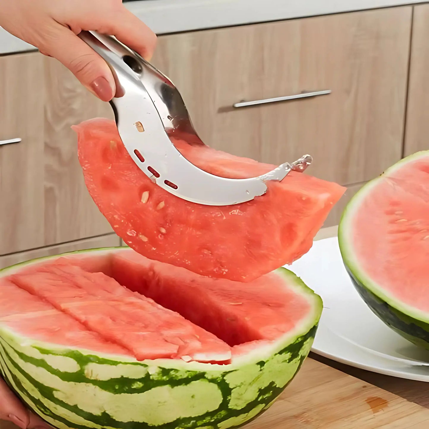Person using a watermelon slice tool to cut a watermelon on a kitchen counter.