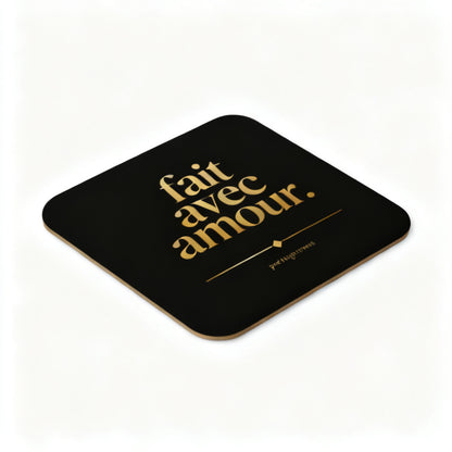 Fait Avec Amour cork-back coaster with gold typography on black showing cork edge detail angled view - petitegourmets