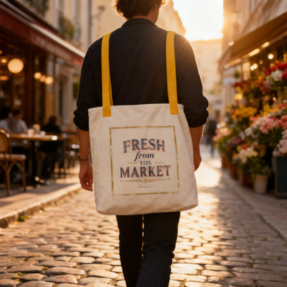 Person carrying Fresh From The Market canvas tote bag walking down a cobblestone European street at golden hour - petitegourmets